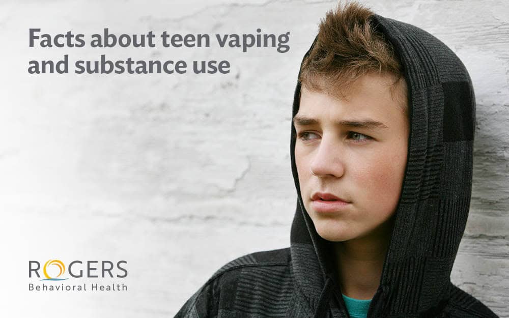 The image features a close-up of a teenager wearing a dark, checkered hoodie, looking thoughtfully to the right. The background is a white, textured wall, giving the image a contrast between the subject and the backdrop. The text is positioned on the left side with information about teen vaping and substance use. The lighting is soft, highlighting the teen's facial features.