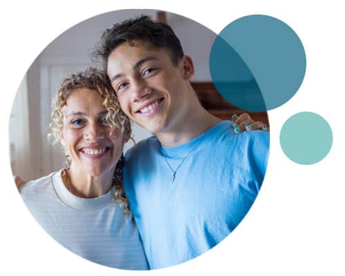 A mother and teenage son smiling together, overlaid with blue circles.