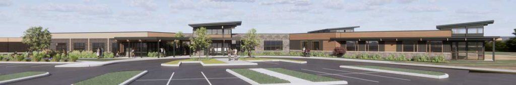 Modern single-story building with large windows and landscaped surroundings.